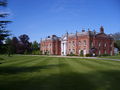 View from across the lawn, with copper beech trees
